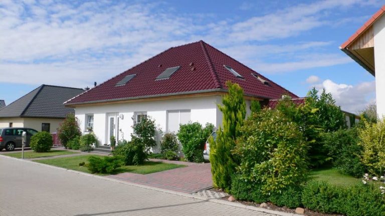 Bungalow Grabow mit rotem Walmdach und Vorgarten